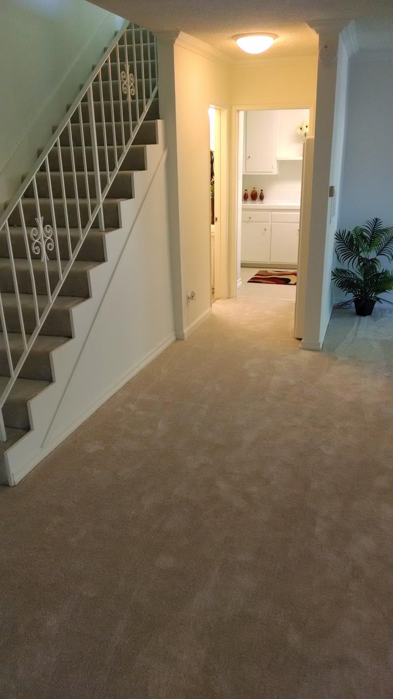 Photo of a hallway and staircase in a unit